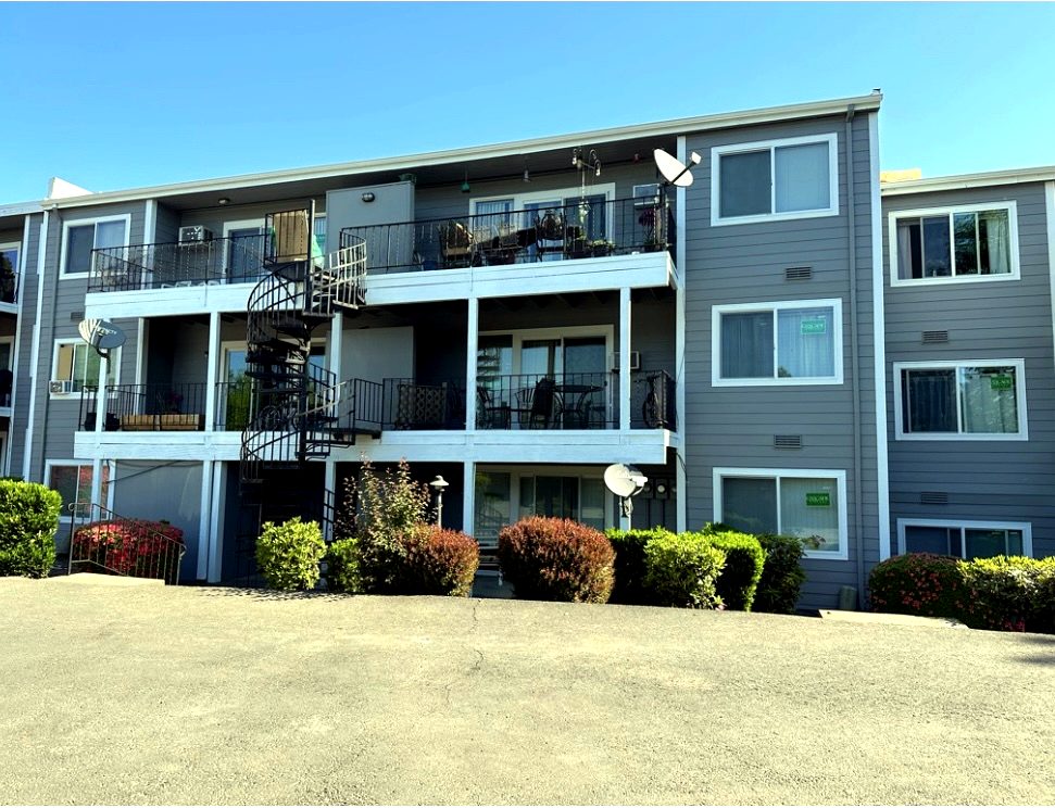 Exterior of a Pacific Northwest building with updated windows and siding